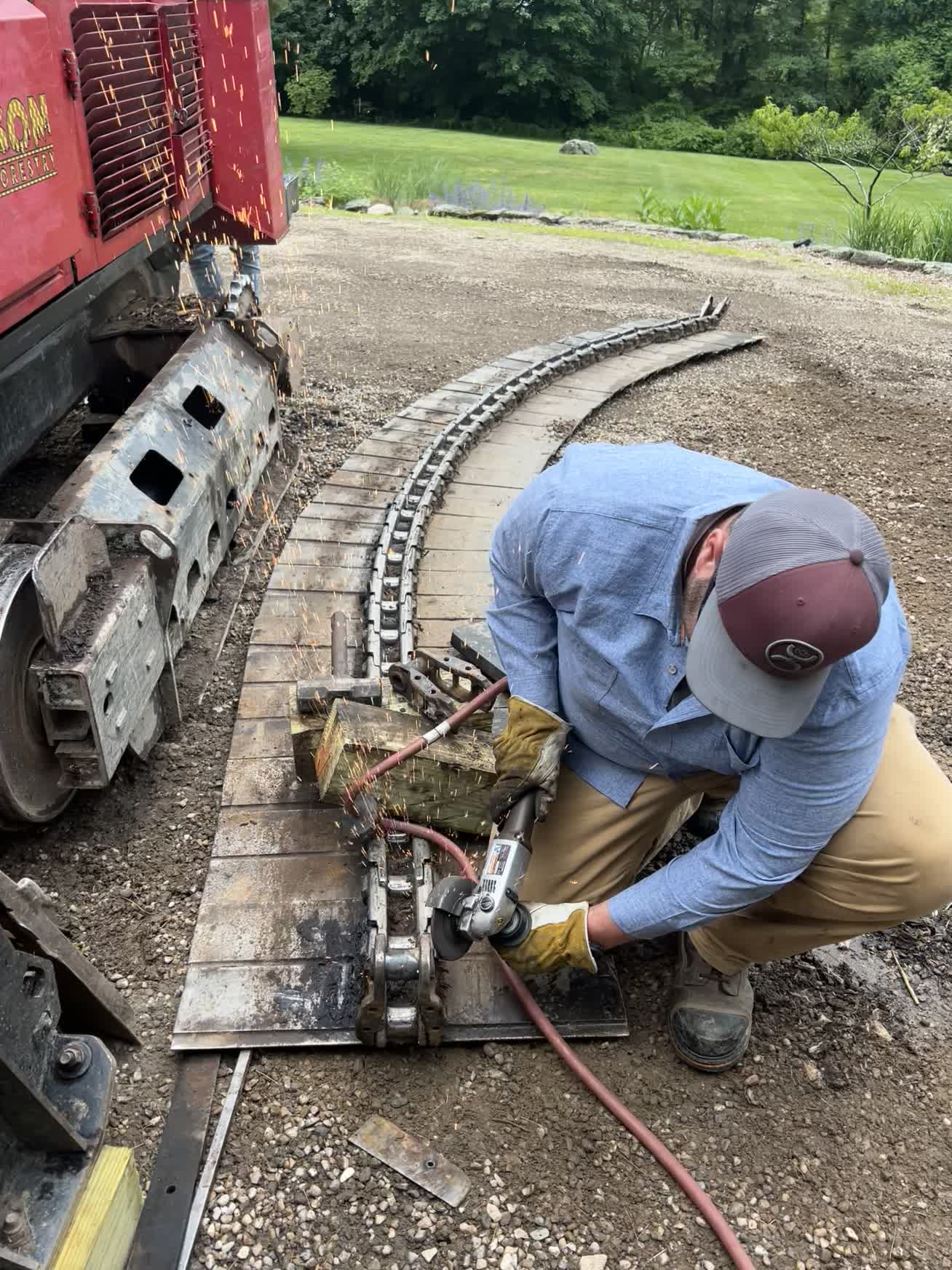 Craftsman working with angle grinder throwing sparks
