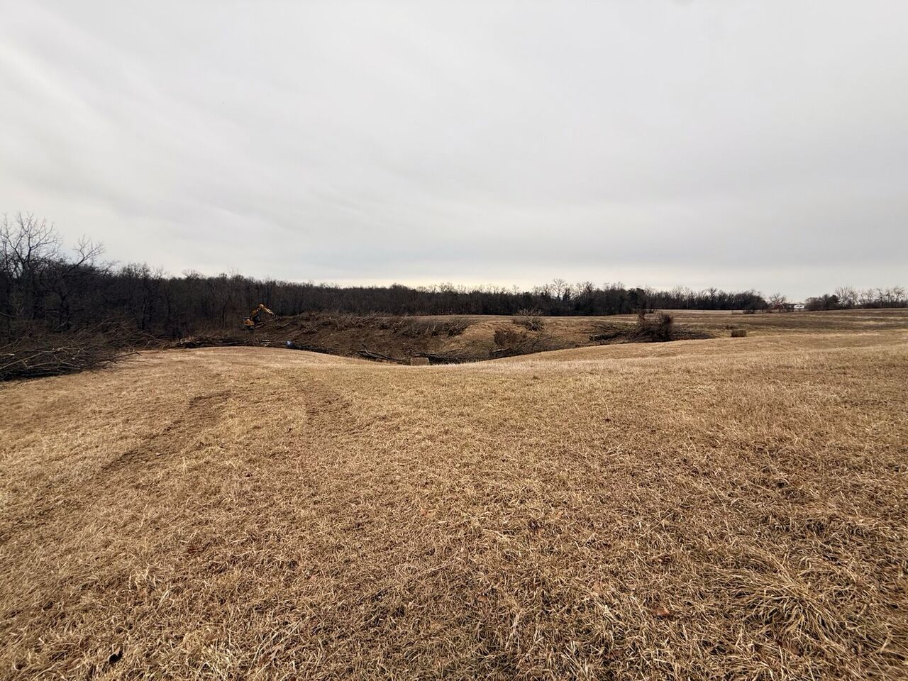 Wide view of the cleared and graded right-of-way corridor cutting across open terrain